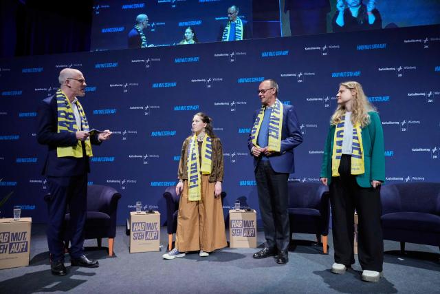 German Chancellor Friedrich Merz (2ndR) attends a panel discussion with young people during the “Deutscher Katholikentag”, a congress of the German Catholic people, in Wuerzburg, southern Germany, on May 15, 2026. (Photo by Matthias Schrader / POOL / AFP)