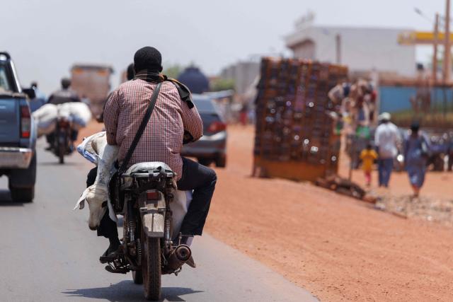 A motorcyclist transports a sheep ahead of the Muslim festival of Eid al-Adha, locally known as Tabaski, in Bamako May 14, 2026. Since April 30, the jihadists have blocked several key routes leading into Bamako which is disrupting livestock supply routes, delaying the arrival of sheep and driving up prices ahead of Eid al-Ahda. Mali is on edge following large-scale, coordinated attacks on the ruling military junta conducted on April 25 and 26 by Al-Qaeda-linked jihadists and Tuareg separatists. (Photo by AFP)