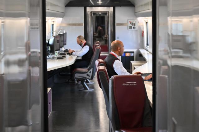 Technicians work aboard a diagnostic train named Diamante 2.0 which reaches a speed of 300 km/h and inspects high-speed lines, in Naples trains station on May 15, 2026. Diamante 2.0 is a train in the Rete Ferroviaria Italiana (RFI) fleet; the special train uses 98 cameras and over 200 sensors placed on the roof and on the trolleys near the wheels to monitor over 500 parameters to collect data on the infrastructure, useful for promptly eliminating possible causes of anomalies and for supporting the scheduling and planning of maintenance operations to be carried out. (Photo by Alberto PIZZOLI / AFP)