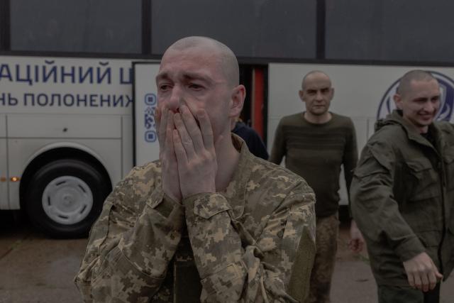 A released Ukrainian prisoner of war (POW) reacts following a prisoner exchange at an undisclosed location, in the Chernihiv region on May 15, 2026, amid the Russian invasion of Ukraine. Russia and Ukraine exchanged 205 prisoners of war each on May 15, Moscow and Kyiv said, a week after US President Donald Trump announced a large swap would take place between the warring sides. (Photo by Roman PILIPEY / AFP)