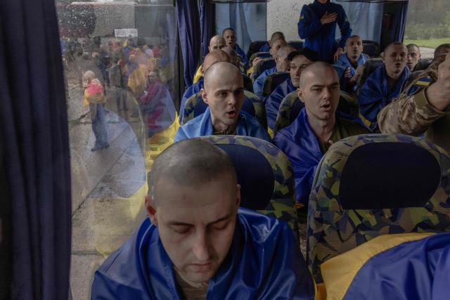 Released Ukrainian prisoners of war (POWs) sing the national anthem on a bus following a prisoner exchange at an undisclosed location, in the Chernihiv region on May 15, 2026, amid the Russian invasion of Ukraine. Russia and Ukraine exchanged 205 prisoners of war each on May 15, Moscow and Kyiv said, a week after US President Donald Trump announced a large swap would take place between the warring sides. (Photo by Roman PILIPEY / AFP)