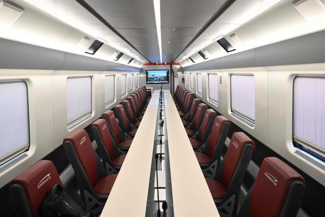 A picture shows the meeting room aboard a diagnostic train named Diamante 2.0 which reaches a speed of 300 km/h and inspects high-speed lines, during a trip between Rome and Naples, on May 15, 2026. Diamante 2.0 is a train in the Rete Ferroviaria Italiana (RFI) fleet; the special train uses 98 cameras and over 200 sensors placed on the roof and on the trolleys near the wheels to monitor over 500 parameters to collect data on the infrastructure, useful for promptly eliminating possible causes of anomalies and for supporting the scheduling and planning of maintenance operations to be carried out. (Photo by Alberto PIZZOLI / AFP)