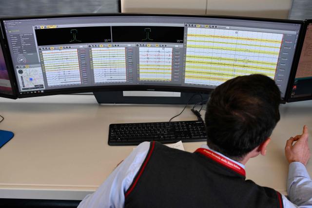 A technician works on screens aboard a diagnostic train named Diamante 2.0 which reaches a speed of 300 km/h and inspects high-speed lines, during a trip between Rome and Naples, on May 15, 2026. Diamante 2.0 is a train in the Rete Ferroviaria Italiana (RFI) fleet; the special train uses 98 cameras and over 200 sensors placed on the roof and on the trolleys near the wheels to monitor over 500 parameters to collect data on the infrastructure, useful for promptly eliminating possible causes of anomalies and for supporting the scheduling and planning of maintenance operations to be carried out. (Photo by Alberto PIZZOLI / AFP)