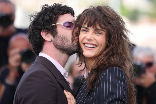 TOPSHOT - US director and screenwriter Jordan Firstman kisses on the cheek British model Cara Delevingne during a photocall of the film "Club Kid" at the 79th edition of the Cannes Film Festival in Cannes, southern France on May 15, 2026. (Photo by Valery HACHE / AFP)