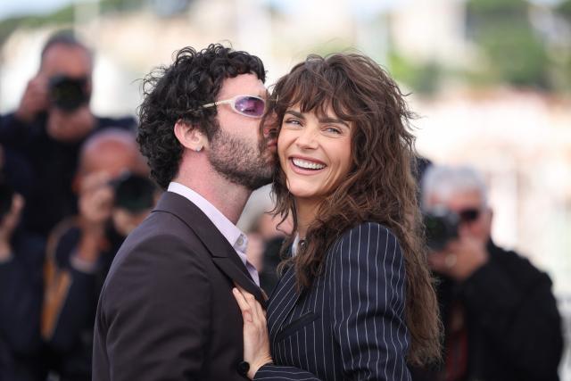 US director and screenwriter Jordan Firstman kisses on the cheek British model Cara Delevingne during a photocall of the film "Club Kid" at the 79th edition of the Cannes Film Festival in Cannes, southern France on May 15, 2026. (Photo by Valery HACHE / AFP)