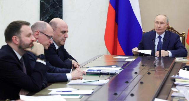 In this pool photograph distributed by the Russian state agency Sputnik, Russia's President Vladimir Putin chairs a meeting on economic issues in Moscow on May 15, 2026. (Photo by Mikhail METZEL / POOL / AFP)