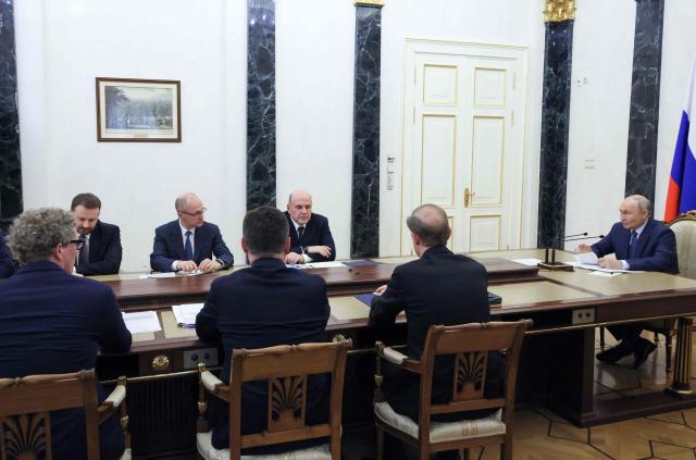 In this pool photograph distributed by the Russian state agency Sputnik, Russia's President Vladimir Putin chairs a meeting on economic issues in Moscow on May 15, 2026. (Photo by Mikhail METZEL / POOL / AFP)