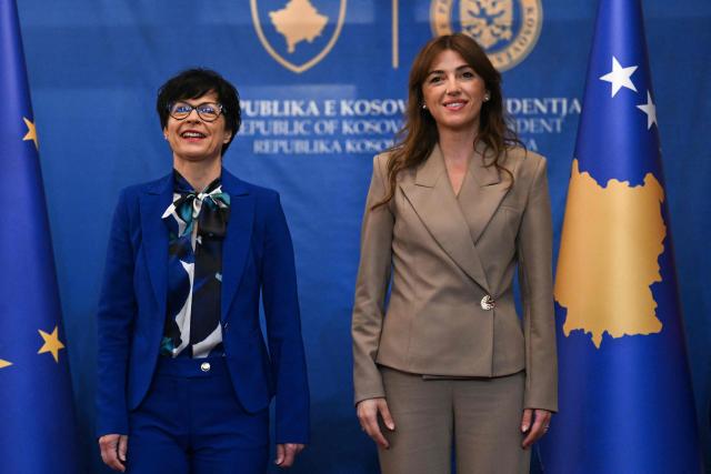 Kosovo's acting President Albulena Haxhiu (R) greets EU Commissioner for Enlargement Marta Kos in Pristina on May 15, 2026. (Photo by Armend NIMANI / AFP)