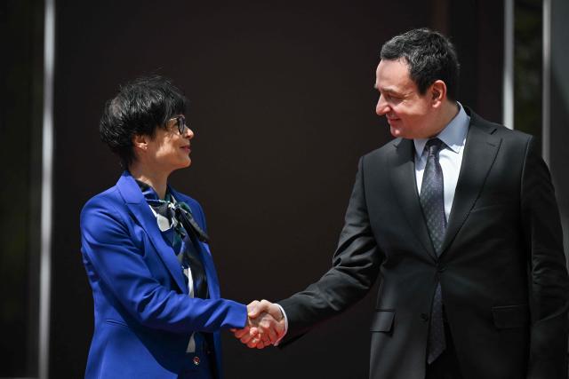 Kosovo's Prime Minister Albin Kurti greets EU Commissioner for Enlargement Marta Kos (L) in Pristina on May 15, 2026. (Photo by Armend NIMANI / AFP)