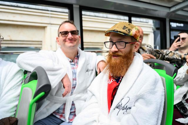 Members of the Eurovision Song Contest (ESC) Fan Club attend a bus tour in Vienna, on May 15, 2026, on the eve of the 2026 Eurovision Song Contest (ESC) final. (Photo by MAX SLOVENCIK / APA / AFP) / Austria OUT