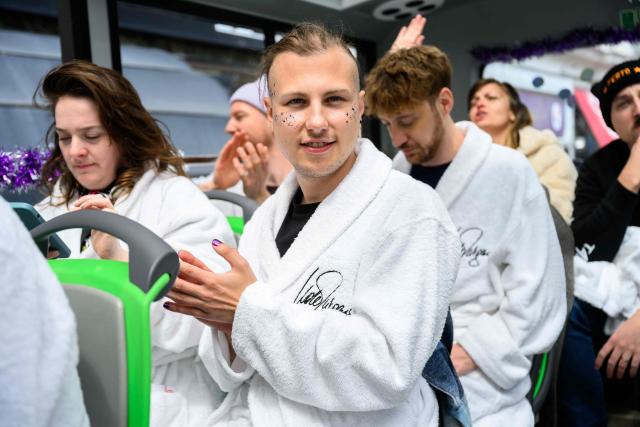 Members of the Eurovision Song Contest (ESC) Fan Club attend a bus tour in Vienna, on May 15, 2026, on the eve of the 2026 Eurovision Song Contest (ESC) final. (Photo by MAX SLOVENCIK / APA / AFP) / Austria OUT