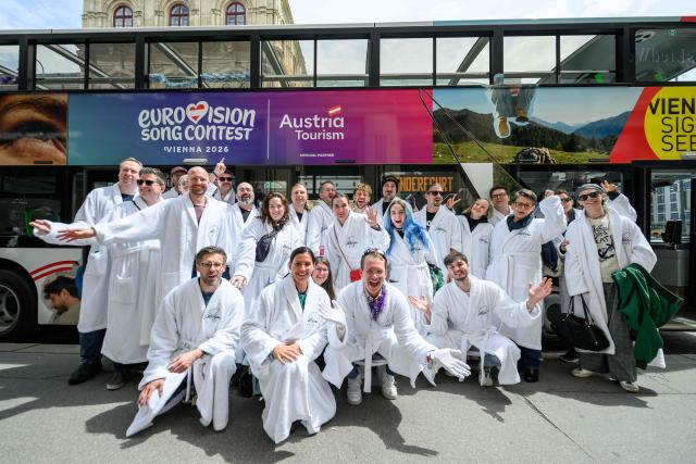 Members of the Eurovision Song Contest (ESC) Fan Club pose in front of a bus in Vienna, on May 15, 2026, on the eve of the 2026 Eurovision Song Contest (ESC) final. (Photo by MAX SLOVENCIK / APA / AFP) / Austria OUT