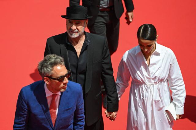 British producer Sean Richard (L), French former football player and actor Eric Cantona (C-L) and French actress Rachida Brakni arrives for the screening of the film "Cantona" at the 79th edition of the Cannes Film Festival in Cannes, southern France on May 15, 2026. (Photo by Antonin THUILLIER / AFP)