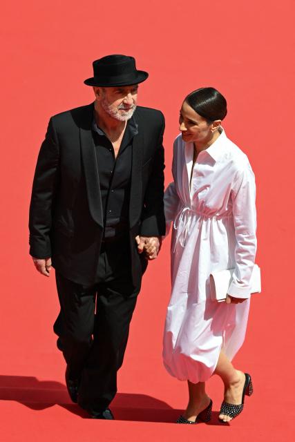 French former football player and actor Eric Cantona and her wife French actress Rachida Brakni arrive for the screening of the film "Cantona" at the 79th edition of the Cannes Film Festival in Cannes, southern France on May 15, 2026. (Photo by Antonin THUILLIER / AFP)