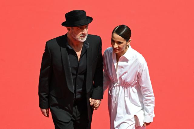 French former football player and actor Eric Cantona and her wife French actress Rachida Brakni arrive for the screening of the film "Cantona" at the 79th edition of the Cannes Film Festival in Cannes, southern France on May 15, 2026. (Photo by Antonin THUILLIER / AFP)