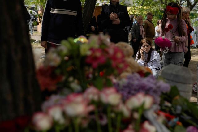 Local residents gather at a makeshift memorial near a partially destroyed residential building in Kyiv on May 15, 2026, amid the Russian invasion of Ukraine. Ukraine's capital Kyiv was in mourning on May 15, 2026, after a Russian attack killed 24 people a day earlier, with President Volodymyr Zelensky denouncing Moscow's "brutal terror" as the two sides went ahead with an exchange of hundreds of captured soldiers. (Photo by Tetiana DZHAFAROVA / AFP)
