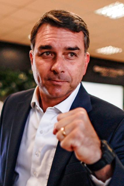 Brazilian Senator Flavio Bolsonaro, son of former President Jair Bolsonaro (2019-2022) and a pre-candidate for the presidency, poses for photographers upon arrival at the Presidente Juscelino Kubitschek International Airport in Brasilia on May 15, 2026. Brazilian presidential hopeful Flavio Bolsonaro denied wrongdoing on May 13, 2026 after the release of an audio recording in which he asks for money from a banker jailed over a multi-million dollar fraud scandal. (Photo by Sergio Lima / AFP)