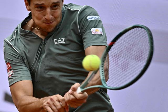 Italy's Luciano Darderi hits a return to Norway's Casper Ruud during their semi-final of the ATP Rome Open tennis tournament at Foro Italico in Rome on May 15, 2026. (Photo by Filippo MONTEFORTE / AFP)