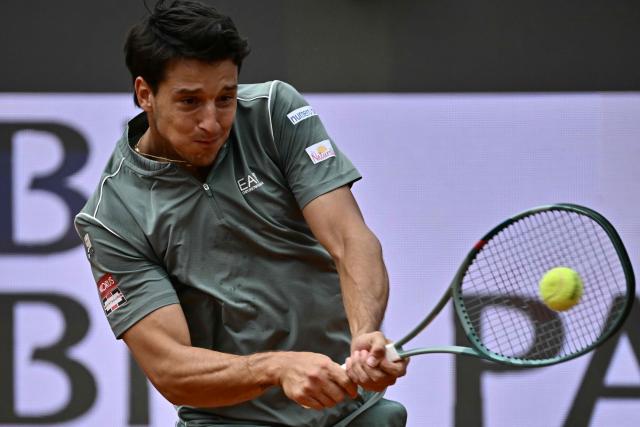 Italy's Luciano Darderi hits a return to Norway's Casper Ruud during their semi-final of the ATP Rome Open tennis tournament at Foro Italico in Rome on May 15, 2026. (Photo by Filippo MONTEFORTE / AFP)