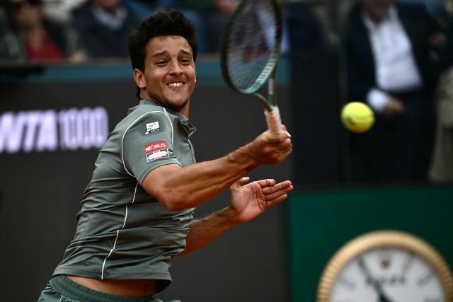 Italy's Luciano Darderi hits a return to Norway's Casper Ruud during their semi-final of the ATP Rome Open tennis tournament at Foro Italico in Rome on May 15, 2026. (Photo by Filippo MONTEFORTE / AFP)