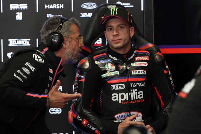 Team Aprilia Racing's Marco Bezzecchi listens to a team member during a practice session ahead of the Catalunya Moto GP Grand Prix at the Catalunya racetrack in Montmelo, near Barcelona, on May 15, 2026. (Photo by LLUIS GENE / AFP)