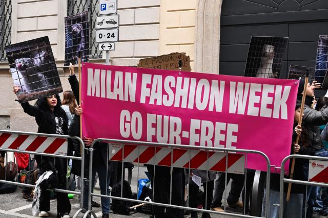 (FILES) Protestors hold signs reading "Milan Fashion Week go fur-free" ahead of the Giorgio Armani womens's ready-to-wear Fall/Winter 2026 collection fashion show as part of the Milan Fashion Week, in Milan on March 1, 2026. On May 15, 2006, the organizing committee of Milan Fashion Week “urged” fashion brands to avoid using fur in their shows, a decision taken following lengthy discussions with NGOs. (Photo by Miguel MEDINA / AFP)