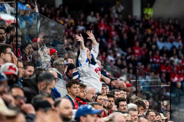 A fan cheers during the group A match between Finland and Germany at the IIHF Ice Hockey Men's World Championship at Swiss Life Arena, in Zurich on May 15, 2026 (Photo by ENNIO LEANZA / AFP)