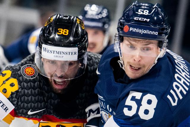Germany's defender #38 Fabio Wagner (L) fights for the puck against Finland's defender #58 Urho Vaakanainen (R) during the group A match between Finland and Germany, at the IIHF Ice Hockey Men's World Championship at Swiss Life Arena, in Zurich on May 15, 2026. (Photo by ENNIO LEANZA / AFP)