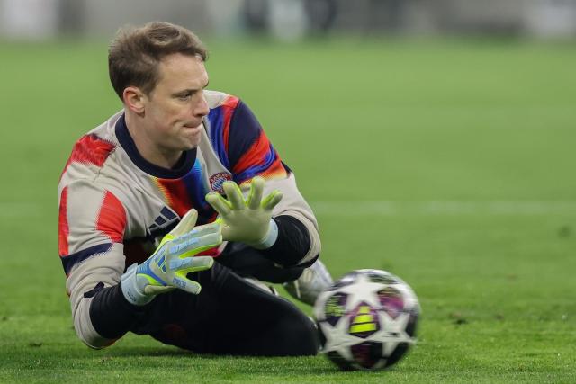 (FILES) Bayern Munich's German goalkeeper #01 Manuel Neuer gets down to makes a save during the warm up prior to the UEFA Champions League quarter-final second leg football match between FC Bayern Munich and Real Madrid in Munich, southern Germany, on April 15, 2026. Bayern Munich veteran Manuel Neuer announced on May 15, 2026 that he has extended his contract at the German champions by one year until 2027. The 40-year-old goalkeeper's deal was set to expire in the summer but he will stay on in Munich for what will be a 16th year at the Bavarian giants. (Photo by Alexandra BEIER / AFP)