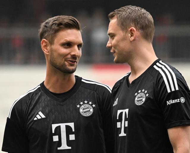 (FILES) Bayern Munich's goalkeeper Manuel Neuer (R) and Bayern Munich's goalkeeper Sven Ulreich (L) talk during the team presentation of the German first division Bundesliga club Bayern Munich in the stadium in Munich, southern Germany, on July 23, 2023. Bayern Munich veteran Manuel Neuer announced on May 15, 2026 that he has extended his contract at the German champions by one year until 2027. Bayern have also extended the contract of third-string goalkeeper Sven Ulreich for a further season. (Photo by Christof STACHE / AFP)