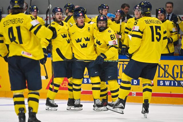 Sweden's teammates celebrfate after scoring their team's second goal during the IIHF Ice Hockey Men's World Championship first round group B ice hockey match between Canada and Sweden at the BFC Arena, in Fribourg, Switzerland on May 15, 2026. (Photo by Fabrice COFFRINI / AFP)