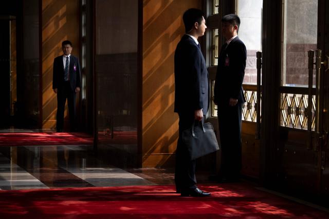 Chinese security wait inside the Great Hall of the People as preparations are made for the arrival of US President Donald J. Trump before a meeting with China's President Xi Jinping on May 14, 2026, in Beijing, China. US President Donald Trump said he had made "fantastic trade deals" with China's Xi Jinping, as the pair met on May 15 at final talks of a superpower summit that according to the US leader has also reaped a Chinese offer to help open the Strait of Hormuz. (Photo by Brendan Smialowski / AFP)