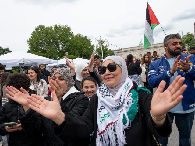 Participants react during a pro-Palestinian demonstration under the motto 'Song Protest Vienna 2026 - No Stage for Genocide' against Israel's participation in the Eurovision Song Contest (ESC), in front of the Maria Theresa Monument in Vienna, Austria, on May 15, 2026. (Photo by Joe Klamar / AFP)