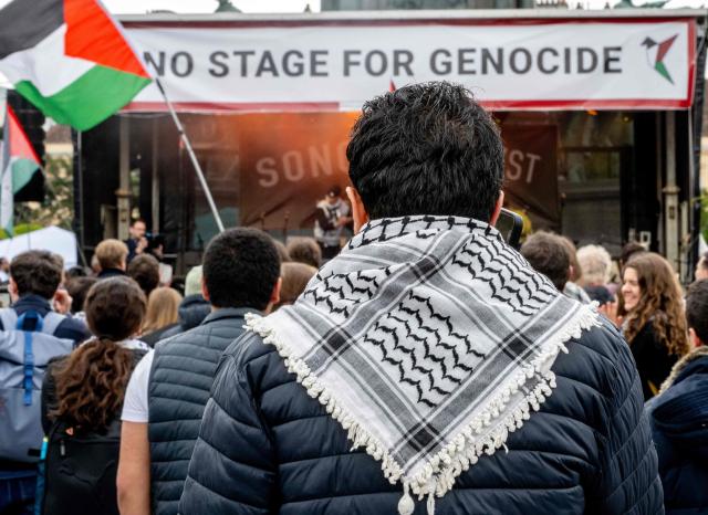 A participant is seen wearing a keffiyeh during a pro-Palestinian demonstration under the motto 'Song Protest Vienna 2026 - No Stage for Genocide' against Israel's participation in the Eurovision Song Contest (ESC), in front of the Maria Theresa Monument in Vienna, Austria, on May 15, 2026. (Photo by Joe Klamar / AFP)