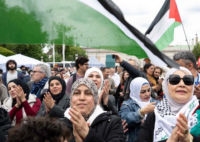 Participants react during a pro-Palestinian demonstration under the motto 'Song Protest Vienna 2026 - No Stage for Genocide' against Israel's participation in the Eurovision Song Contest (ESC), in Vienna, Austria, on May 15, 2026. (Photo by Joe Klamar / AFP)