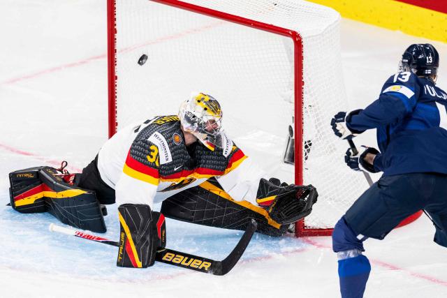 Finland's forward #13 Jesse Puljujarvi (R) scores against Germany's goalkeeper #30 Philipp Grubauer (L) during the group A match between Finland and Germany, at the IIHF Ice Hockey Men's World Championship at Swiss Life Arena, in Zurich on May 15, 2026. (Photo by ENNIO LEANZA / AFP)