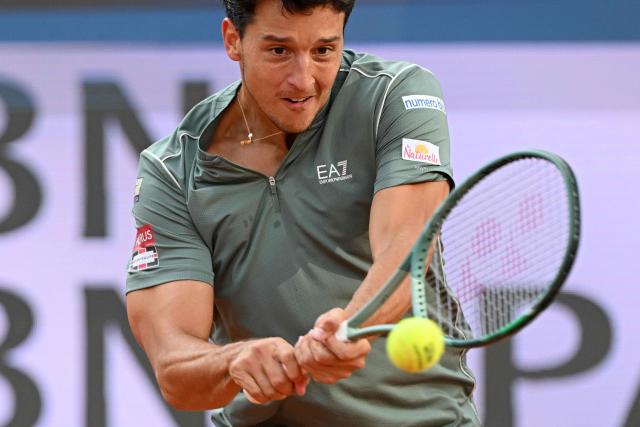Italy's Luciano Darderi hits a return to Norway's Casper Ruud during their semi-final of the ATP Rome Open tennis tournament at Foro Italico in Rome on May 15, 2026. (Photo by Tiziana FABI / AFP)