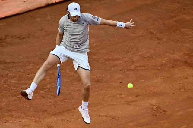 Norway's Casper Ruud hits a return to Italy's Luciano Darderi during their semi-final of the ATP Rome Open tennis tournament at Foro Italico in Rome on May 15, 2026. (Photo by Filippo MONTEFORTE / AFP)