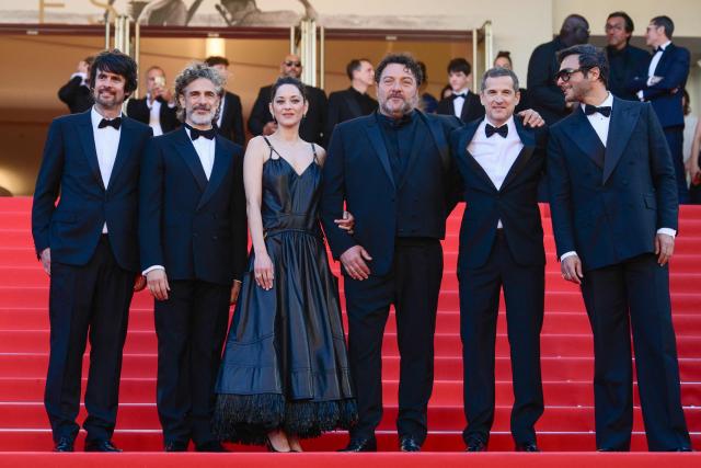 (From L) French screenwriter Simon Jacquet, Argentinian actor Leonardo Sbaraglia, French actress Marion Cotillard, French actor Denis Menochet, French actor Guillaume Canet and French composer Maxim Nucci arrive for the screening of the film "Karma" at the 79th edition of the Cannes Film Festival in Cannes, southern France on May 15, 2026. (Photo by Olivier CHASSIGNOLE / AFP)