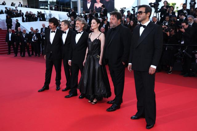 French screenwriter Simon Jacquet, French director and screenwriter Guillaume Canet, Argentinian actor Leonardo Sbaraglia, French actress Marion Cotillard, French actor Denis Menochet and French composer Maxim Nucci arrive for the screening of the film "Karma" at the 79th edition of the Cannes Film Festival in Cannes, southern France on May 15, 2026. (Photo by Sameer AL-DOUMY / AFP)
