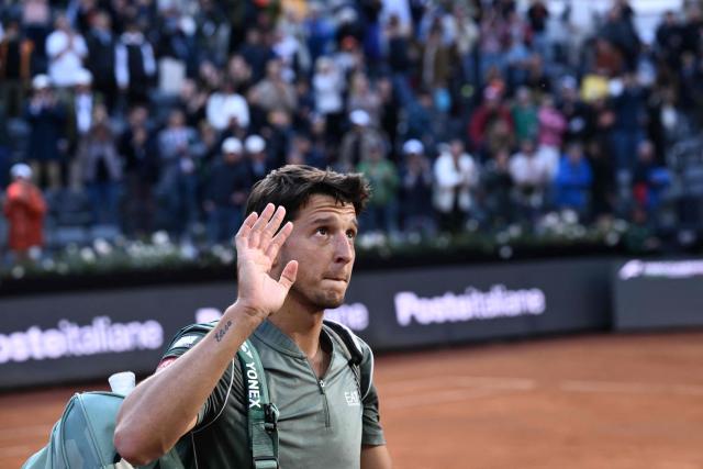 Italy's Luciano Darderi waves to fans as he leaves the court after being defeated by Norway's Casper Ruud in their semi-final at the ATP Rome Open tennis tournament at Foro Italico in Rome on May 15, 2026. (Photo by Tiziana FABI / AFP)