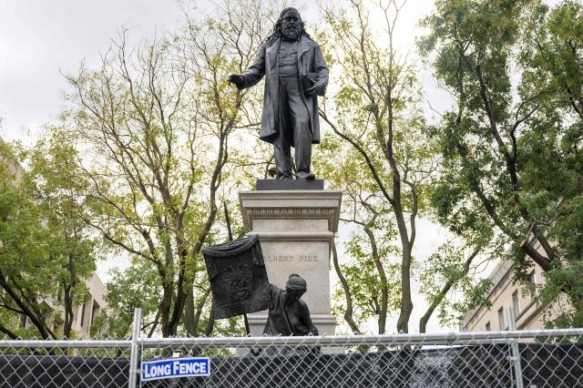 (FILES) View of the statue of Civil War era Confederate General Albert Pike in Washington, DC, on Ocober 28, 2025. An executive order from President Donald Trump on "restoring truth and sanity to American history" is changing how history is told at state-owned landmarks as the United States gears up for its 250th independence anniversary in July. The March 2025 order decrees that all monuments and markers within the jurisdiction of the Interior Department -- the parent agency of the park service -- must focus on the "greatness" of US achievements and not "inappropriately disparage Americans past or living." Last October, the only outdoor monument in Washington to honor a Confederate general -- a statue of Albert Pike -- was restored. (Photo by Jim WATSON / AFP)
