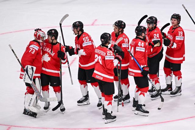 Canada’s players celebrates at the end of the IIHF Ice Hockey Men's World Championship first round group B ice hockey match between Canada and Sweden at the BFC Arena, in Fribourg, Switzerland on May 15, 2026. Canada wins 5 - 3 against Sweden. (Photo by Fabrice COFFRINI / AFP)