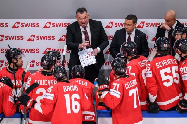 Canada’s head coach Misha Donskov (C) gestures as he speaks to his players during the IIHF Ice Hockey Men's World Championship first round group B ice hockey match between Canada and Sweden at the BFC Arena, in Fribourg, Switzerland on May 15, 2026. (Photo by Fabrice COFFRINI / AFP)
