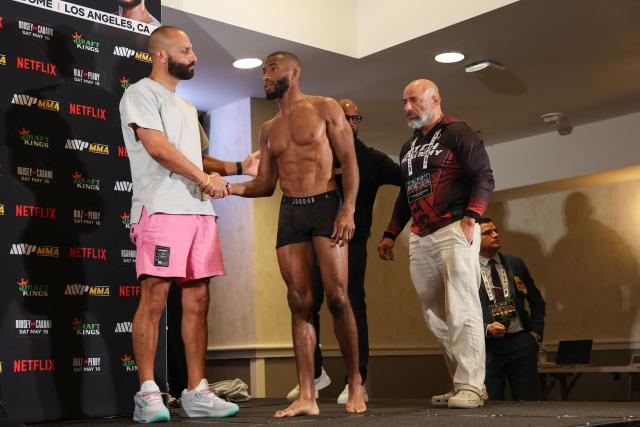 Nakisa Bidarian, CEO of Most Valuable Promotions, shakes hands with French Mixed Martial Arts (MMA) fighter Salahdine Parnasse (R) before their official weigh-in ahead of the Most Valuable Promotions (MVP) and Netflix Professional MMA fight in Manhattan Beach, California on May 15, 2026. (Photo by Patrick T. Fallon / AFP)