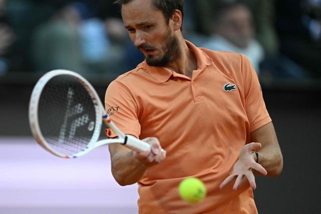 Russia's Daniil Medvedev hits a return to Italy's Jannik Sinner during their semi-final at the ATP Rome Open tennis tournament at Foro Italico in Rome on May 15, 2026. (Photo by Tiziana FABI / AFP)