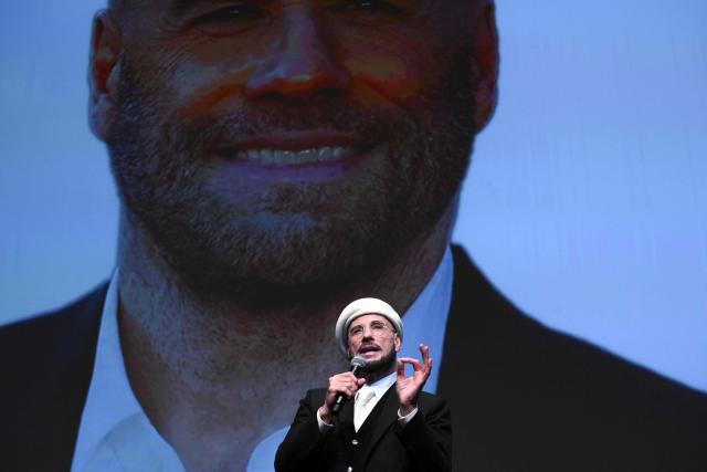 US director, screenwriter and writer John Travolta receives an honourary lifetime achievement Palm d'Or award prior to the screening of the film "Propeller One-Way Night Coach" at the 79th edition of the Cannes Film Festival in Cannes, southern France on May 15, 2026. (Photo by Olivier CHASSIGNOLE / AFP)
