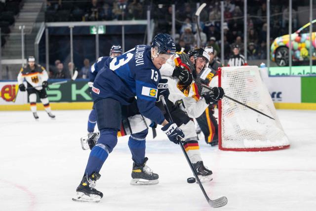 Finland's forward #13 Jesse Puljujarvi (L) and Germany's forward #65 Marc Michaelis (R) fight for the puck during the group A match between Finland and Germany at the IIHF Ice Hockey Men's World Championship in the Swiss Life Arena, Zurich, on May 15, 2026. (Photo by ENNIO LEANZA / AFP)