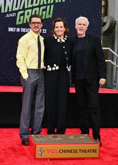 (L/R) Chilean-US actor Pedro Pascal, US actress Sigourney Weaver and US director James Cameron pose after Weaver's hand and footprint ceremony at the TCL Chinese Theatre in Hollywood, California, on May 15, 2026. (Photo by Frederic J. Brown / AFP)