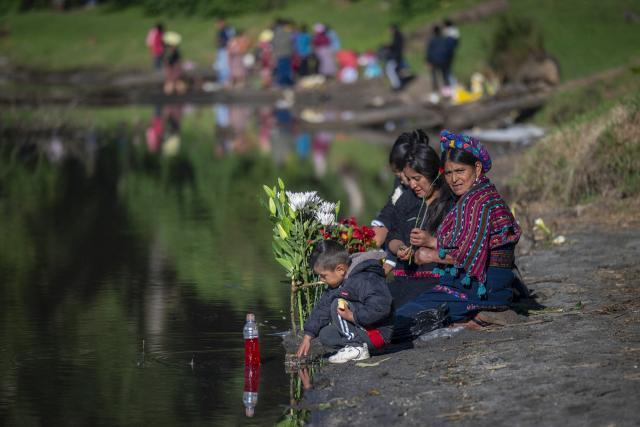 Mam Maya indigenous women take part in the 'Prayer for Rain' ceremony -to bless the crops- on the shore of Chicabal Lagoon, formed in the crater of an extinct volcano and which they consider a sacred place, in San Martin Sacatepequez, Quetzaltenango, Guatemala, on May 14, 2026. (Photo by Carlos ALONZO / AFP)